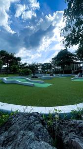 a golf course with green grass and trees in the background at WV 32 Urban Scenic Studio in Sampong