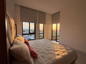 a bedroom with a large bed with large windows at Luxury Condo en Nuevo Vallarta Alberca Tipo Resort in Nuevo Vallarta +48 photos