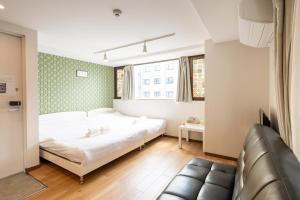 Ένα ή περισσότερα κρεβάτια σε δωμάτιο στο 難波民泊