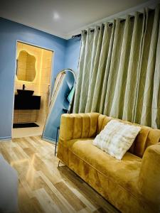 a living room with a couch and a mirror at Y & N BnB in Alberton