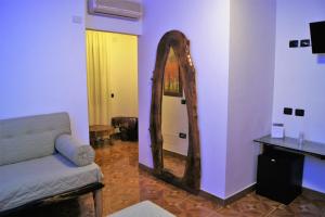 a living room with a mirror and a couch at Villa Masseria Marini in San Giuseppe Vesuviano