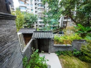 a brick building with a door in a city at Huguang Hidden Villa Hotel in Chongqing