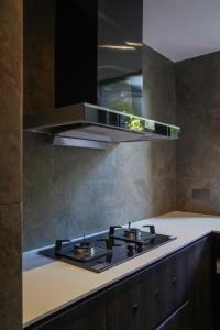 a kitchen with a stove top in a kitchen at Huguang Hidden Villa Hotel in Chongqing +156 photos
