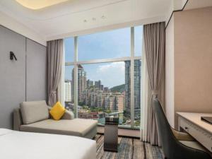 Ένα ή περισσότερα κρεβάτια σε δωμάτιο στο Zhuhai Dehan Hotel