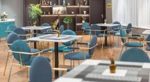 a dining room with tables and blue chairs at Magnotel Shanghai Henglong Plaza in Shanghai