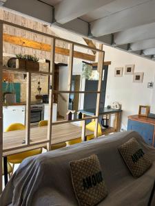 a bedroom with a large bed and a kitchen at Les fontanelles du quercy blanc in Montcuq
