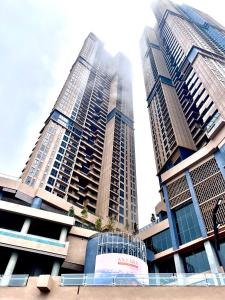 two tall skyscrapers in a city at Antara Genting Premium KL View 2BR Karaoke K2 in Genting Highlands