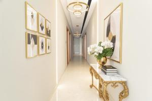 a hallway with a console table and a vase of flowers at FabHotel Penthouse - A K Dev Road in Guwahati