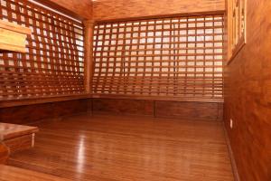 an empty room with a wooden floor and wooden walls at Athithi Inn Homestay in Vaduvanchal