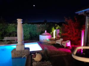 a backyard with a swimming pool at night at tonelle in Montélimar +8 photos