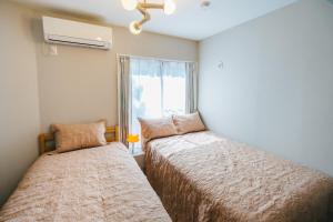 Postel nebo postele na pokoji v ubytování Otter Stay Lite - Shinsakae