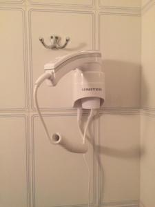 a hair dryer is attached to a wall at Fotini's Beach in Olympic Beach