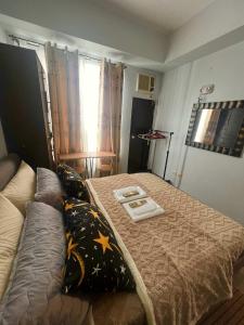 a small bedroom with a bed and a couch at Mezza Residences in Manila +9 photos