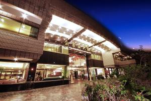 a large building with lights on it at night at The Enterpriser Hotel in Taichung