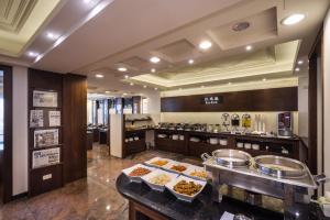 a buffet line with food on display in a restaurant at The Enterpriser Hotel in Taichung +37 photos