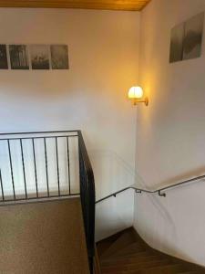 a staircase with a light on the wall and a lightswitch at Falkenstein Loft 55 in Zwiesel