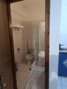 a bathroom with a toilet and a sink at Fotini's Beach in Olympiaki Akti +37 photos