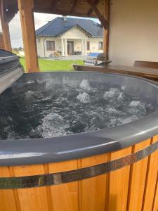 a jacuzzi tub in the backyard of a house at Dworek pod Krzyżtoporem Ujazd Agroturystyka- pokoje do wynajęcia in Iwaniska