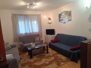 a living room with a couch and a table at Holiday Home Višnja with Pool in Benkovac