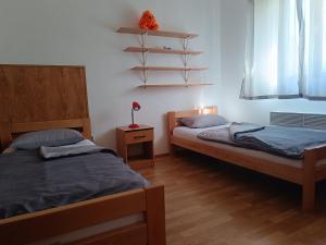 a bedroom with two beds and a lamp on a table at Holiday Home Višnja with Pool in Benkovac +49 photos
