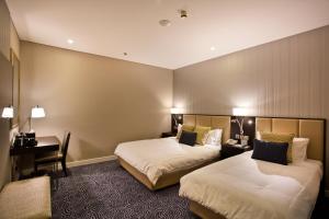 Uma cama ou camas num quarto em Ambassador Transit Hotel - Terminal 3