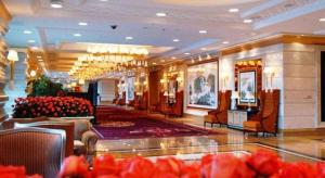 a lobby of a hotel with chairs and a salon at Shenyang Royal Wan Xin Hotel in Shenyang +215 photos