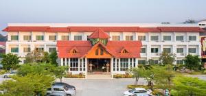 a large building with red roofs in a parking lot at Silayok Grand Hotel in Tak