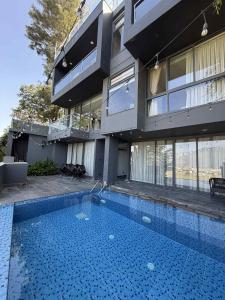 een huis met een zwembad voor een gebouw bij Villa by Bellavista in Pātan