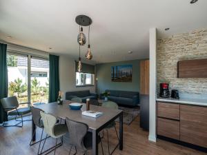 a kitchen and living room with a table and chairs at Beautiful luxurious villa situated in Den Burg in Den Burg