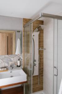 a bathroom with a sink and a shower at Trofonios Boutique Hotel in Levádeia