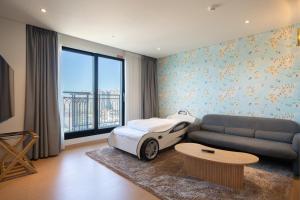 a bedroom with a bed and a car on the wall at Chestertons Gyeongju in Gyeongju