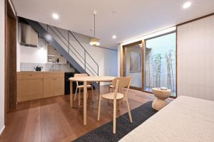 a kitchen and dining room with a table and chairs at casana KYOTO in Kyoto