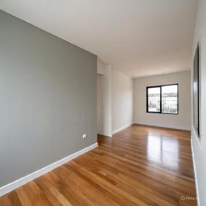 an empty living room with wood floors and a window at XyraaHouse Apart in Kinati