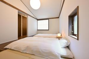 two beds in a room with two windows at casana KYOTO in Kyoto +63 photos