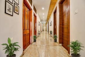 a hallway with potted plants in a building at FabHotel Prime Manjeet in Bhopal
