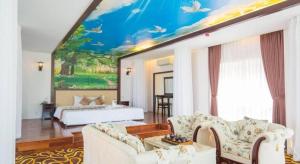 a living room with a large painting on the wall at Sea Mountain Hotel in Vung Tau +46 photos