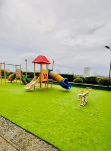 a playground with a slide and slidesktop at Mezza Residences in Manila