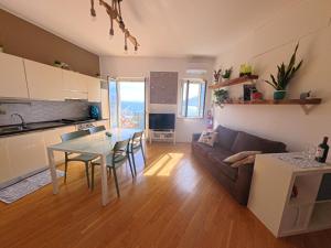 a living room with a couch and a table at Il Balcone sul mare - free parking & relax in Palermo