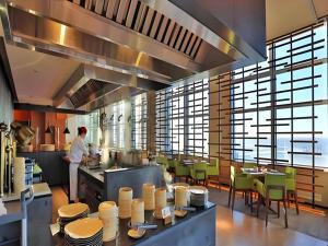 a chef preparing food in a large kitchen at AOLUGUYA in Harbin