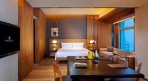 a hotel room with a bed and a dining table at AOLUGUYA in Harbin +105 photos