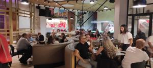 a group of people sitting in a restaurant at Private village apartment in Kirkop