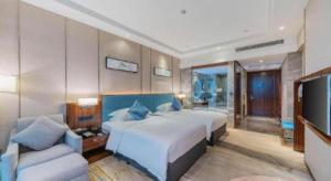a bedroom with a large white bed and a couch at Ramada Foshan Shunde in Shunde +71 photos