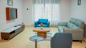 a living room with a couch and a table at Kigali Airport Stay Apartments in Kigali