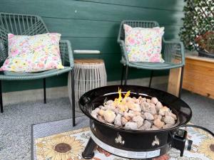 a grill with food in it on a table with chairs at A Room of One's Own-A perfect getaway by the sea in North Nanaimo in Nanaimo
