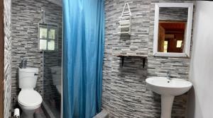 a bathroom with a toilet and a sink at Onda Azul Back Unit A & B in Ponta do Ouro