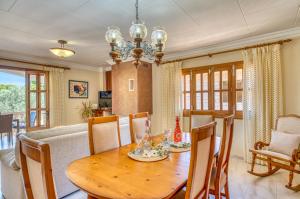 a dining room with a wooden table and chairs at Ideal Property Mallorca - Eden Lago in Alcudia