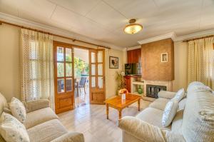 a living room with two couches and a table at Ideal Property Mallorca - Eden Lago in Alcudia