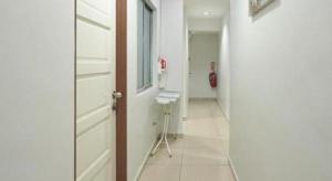 a hallway with a door and a chair in a room at Swing & Pillows @ PJ KD in Sungai Way +29 photos