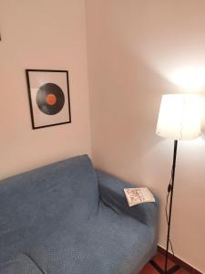 a bedroom with a blue bed and a lamp at B&B case rosse in Salerno +1 photo