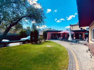 a park with a car parked next to a building at Jabłoń w Ogrodzie in Częstochowa
